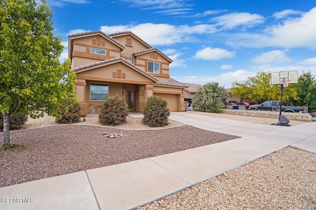 5525 Valley Cedar Dr, El Paso, TX 79932 - view of front facade with concrete driveway, a tiled roof, stucco siding, and a garage