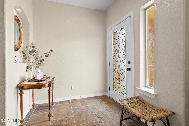 5525 Valley Cedar Dr, El Paso, TX 79932 - entryway with baseboards and stone finish flooring