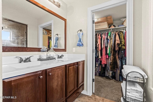 5525 Valley Cedar Dr, El Paso, TX 79932 - full bathroom featuring a spacious closet and double vanity