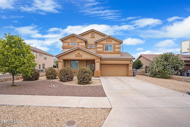 5525 Valley Cedar Dr, El Paso, TX 79932 - mediterranean / spanish home with stucco siding, a garage, driveway, and a tile roof