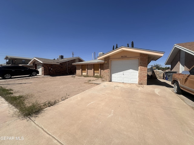 9836 Isaac Dr, El Paso, TX 79927 - view of front facade with an attached garage, concrete driveway, and brick siding