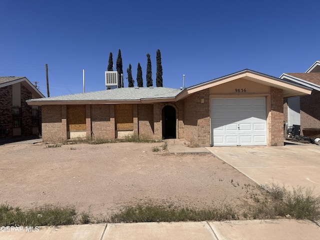 9836 Isaac Dr, El Paso, TX 79927 - ranch-style home featuring a garage, brick siding, driveway, and central air condition unit