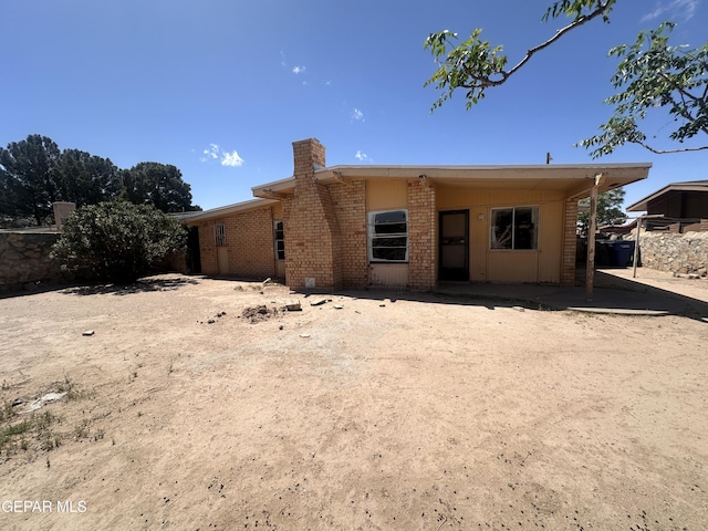 8149 Tranquilo Dr, El Paso, TX 79907 - back of property featuring a chimney and brick siding