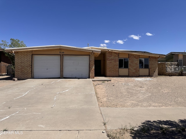 8149 Tranquilo Dr, El Paso, TX 79907 - view of front of house featuring concrete driveway, a garage, and brick siding
