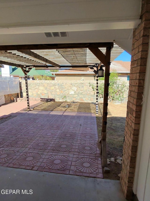 view of patio featuring fence