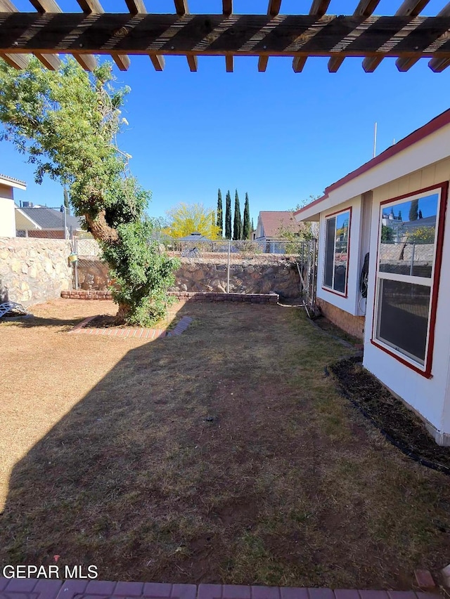 fenced backyard with a pergola