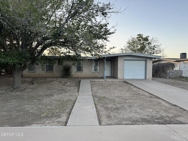 305 Corvena Way, El Paso, TX 79922 - ranch-style home with a garage, brick siding, and driveway