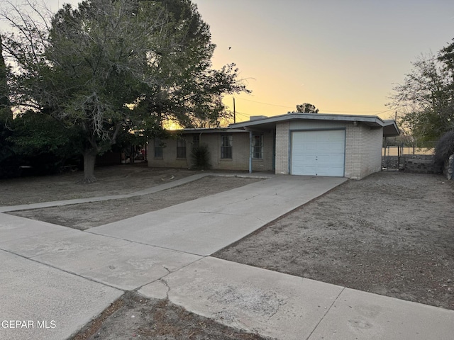 305 Corvena Way, El Paso, TX 79922 - view of front of house featuring an attached garage, brick siding, and concrete driveway