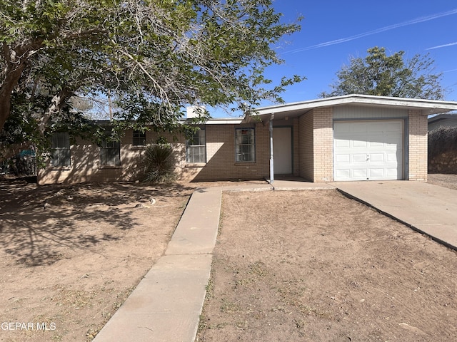 305 Corvena Way, El Paso, TX 79922 - ranch-style house with brick siding, an attached garage, and driveway