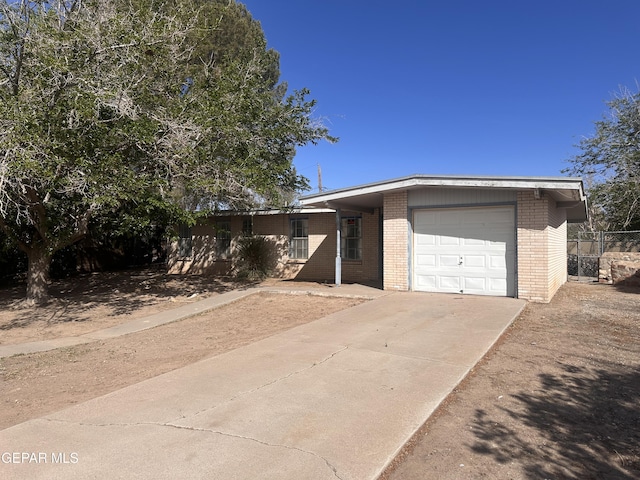 305 Corvena Way, El Paso, TX 79922 - view of front of house with brick siding, a garage, and driveway