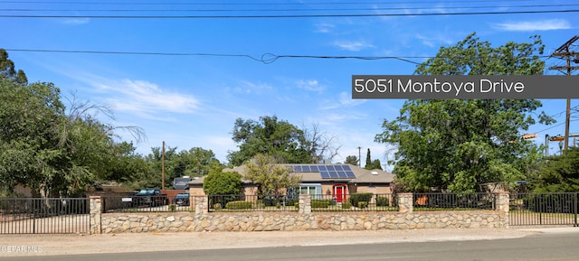 5051 Montoya Dr, El Paso, TX 79922 - view of front of house featuring solar panels and a fenced front yard