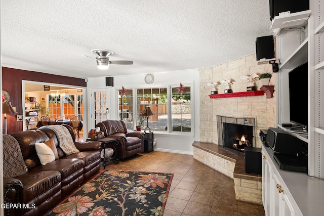5051 Montoya Dr, El Paso, TX 79922 - tiled living room with ceiling fan, a textured ceiling, and a stone fireplace