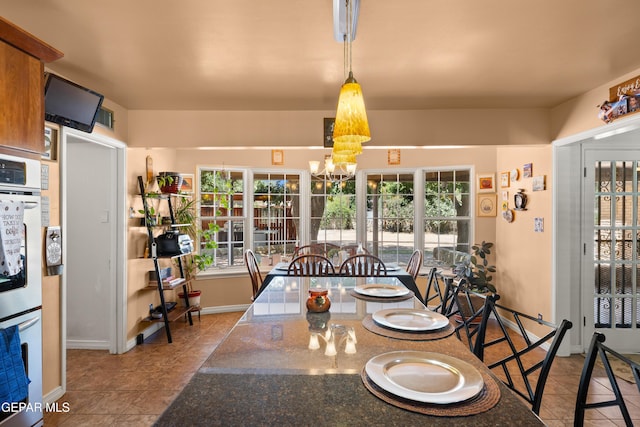 5051 Montoya Dr, El Paso, TX 79922 - tiled dining room featuring a chandelier and baseboards
