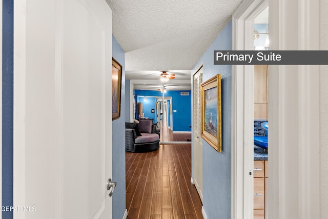 5051 Montoya Dr, El Paso, TX 79922 - hallway with a textured ceiling, dark wood finished floors, and baseboards