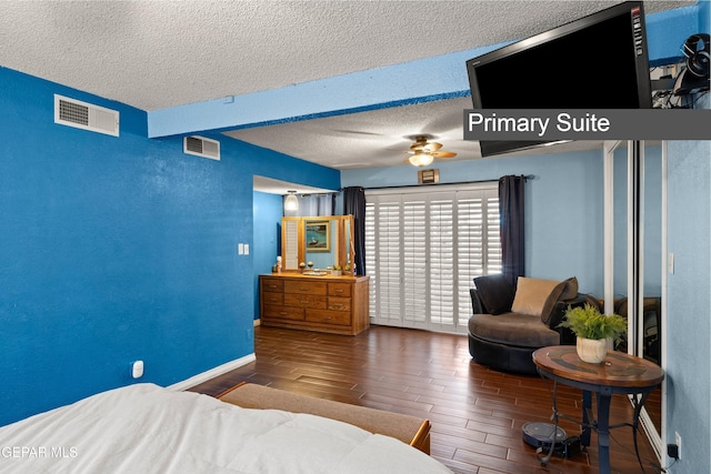 5051 Montoya Dr, El Paso, TX 79922 - bedroom featuring wood finished floors, a textured ceiling, baseboards, and ceiling fan