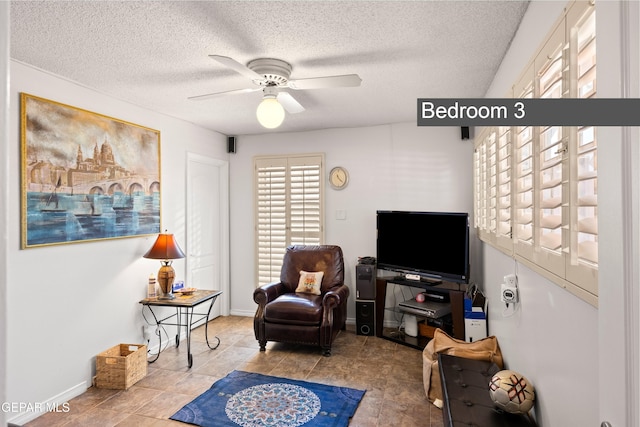 5051 Montoya Dr, El Paso, TX 79922 - sitting room featuring ceiling fan, a textured ceiling, and baseboards