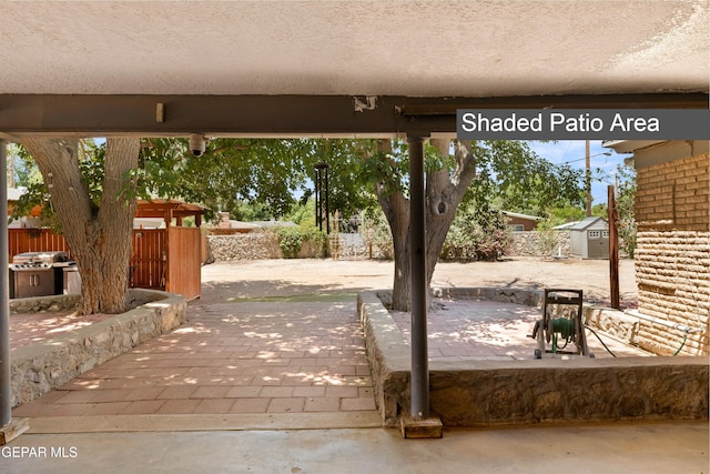 5051 Montoya Dr, El Paso, TX 79922 - view of patio with a shed, an outdoor structure, and fence