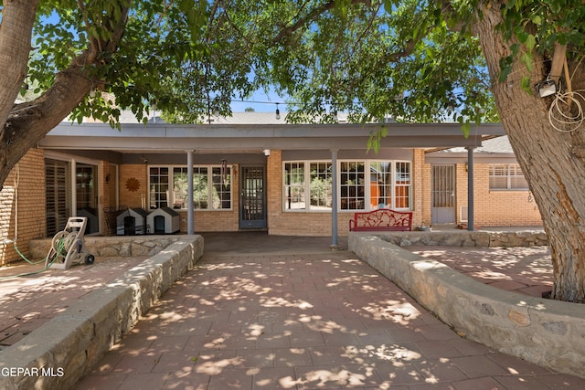 5051 Montoya Dr, El Paso, TX 79922 - rear view of house featuring brick siding and a patio