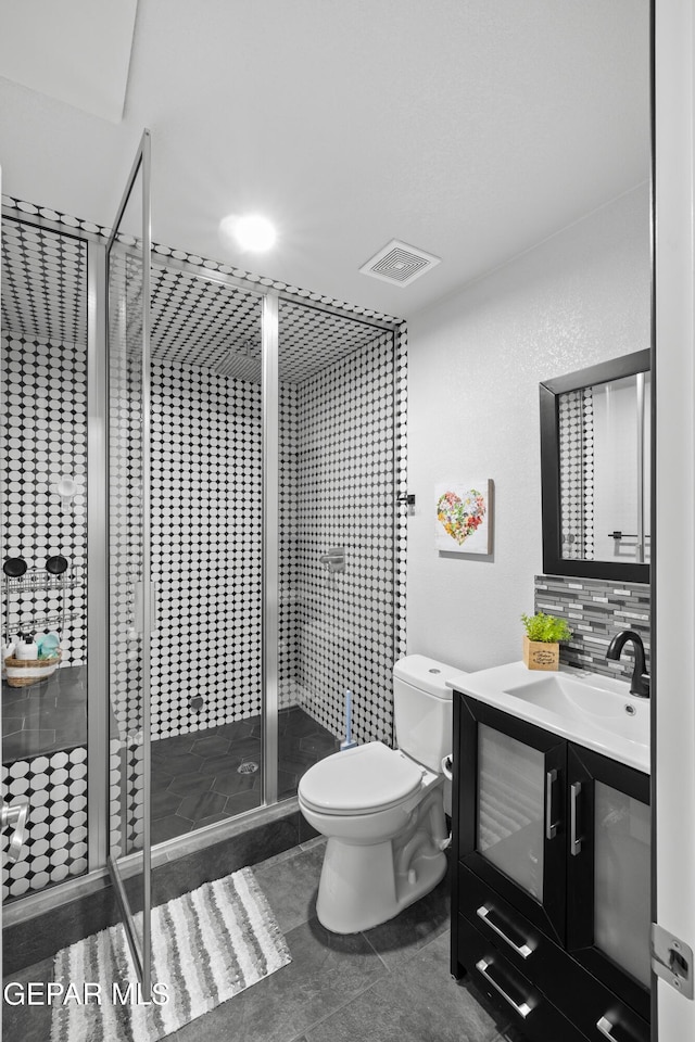 5051 Montoya Dr, El Paso, TX 79922 - bathroom featuring toilet, a shower stall, vanity, tile patterned floors, and backsplash