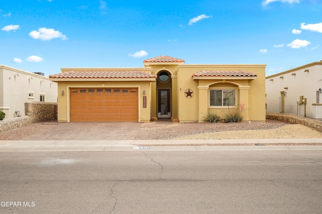 14117 Rainbow Point Dr, El Paso, TX 79938 - mediterranean / spanish home with stucco siding, driveway, an attached garage, and a tiled roof