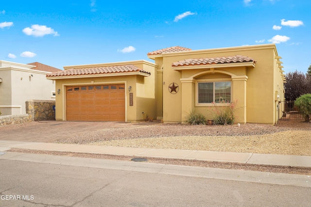 14117 Rainbow Point Dr, El Paso, TX 79938 - mediterranean / spanish home featuring stucco siding, driveway, a garage, and a tiled roof