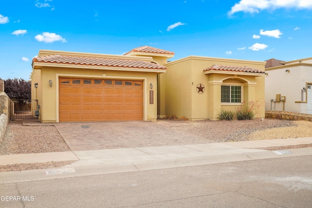 14117 Rainbow Point Dr, El Paso, TX 79938 - mediterranean / spanish-style home with driveway, stucco siding, an attached garage, a gate, and a tile roof