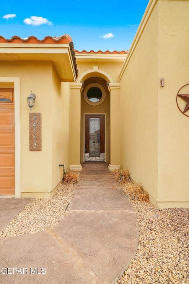 14117 Rainbow Point Dr, El Paso, TX 79938 - view of exterior entry featuring stucco siding and a tile roof