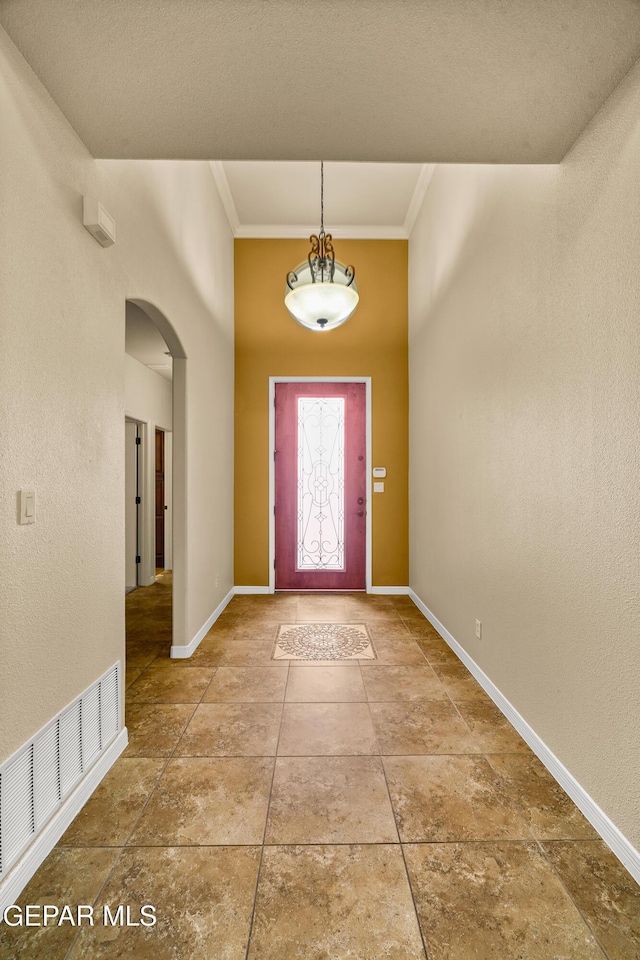 14117 Rainbow Point Dr, El Paso, TX 79938 - foyer entrance with arched walkways, ornamental molding, and a towering ceiling