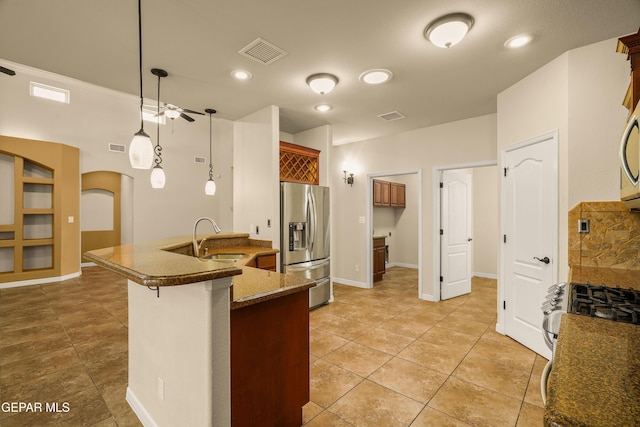 14117 Rainbow Point Dr, El Paso, TX 79938 - kitchen featuring appliances with stainless steel finishes, ceiling fan, hanging light fixtures, light tile patterned floors, and arched walkways
