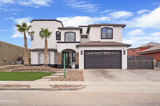 3089 Snowy Point Dr, El Paso, TX 79938 - view of front facade with driveway, a gate, stucco siding, and an attached garage