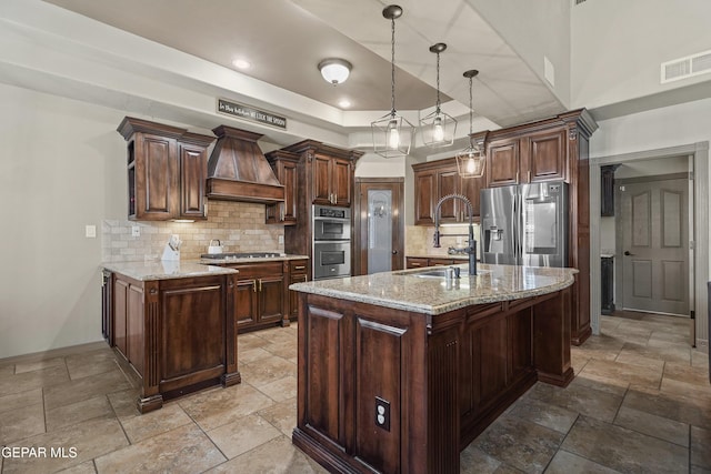3089 Snowy Point Dr, El Paso, TX 79938 - kitchen featuring custom range hood, a sink, stainless steel appliances, backsplash, and stone tile floors