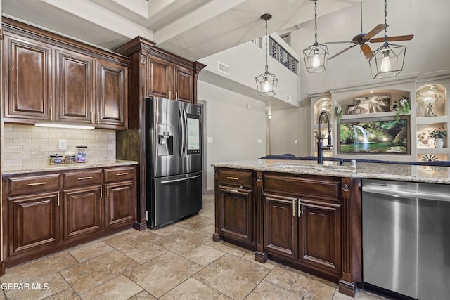 3089 Snowy Point Dr, El Paso, TX 79938 - kitchen with stainless steel appliances, a sink, backsplash, hanging light fixtures, and dark brown cabinets
