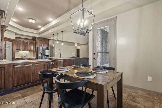 3089 Snowy Point Dr, El Paso, TX 79938 - dining area featuring stone tile floors, a chandelier, baseboards, a raised ceiling, and recessed lighting