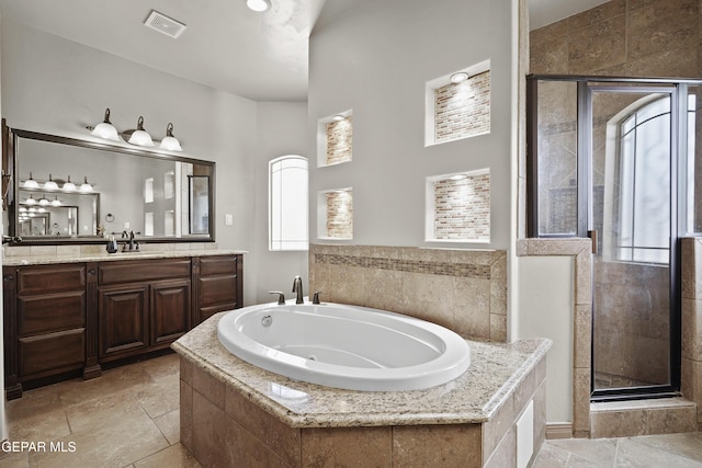 3089 Snowy Point Dr, El Paso, TX 79938 - full bath featuring plenty of natural light, a shower stall, and a tub with jets