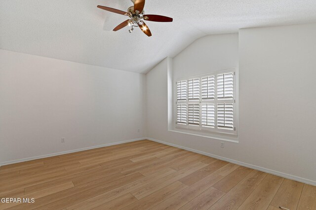 6140 Los Robles Dr, El Paso, TX 79912 - unfurnished room with ceiling fan, vaulted ceiling, wood finished floors, and a textured ceiling