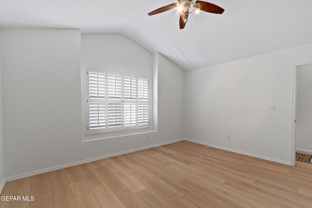 6140 Los Robles Dr, El Paso, TX 79912 - empty room with ceiling fan, vaulted ceiling, light wood-style flooring, and a textured ceiling