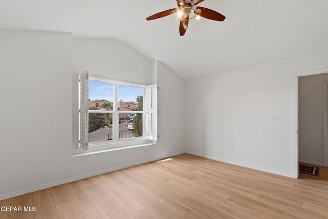 6140 Los Robles Dr, El Paso, TX 79912 - empty room featuring vaulted ceiling, a ceiling fan, and light wood-style flooring