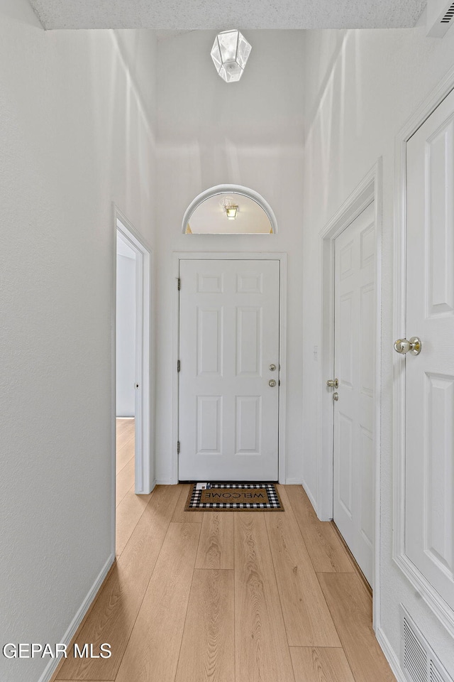 6140 Los Robles Dr, El Paso, TX 79912 - entryway featuring wood finished floors and baseboards