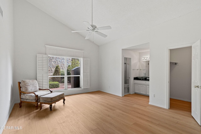 6140 Los Robles Dr, El Paso, TX 79912 - living area with a ceiling fan, light wood-style floors, and high vaulted ceiling