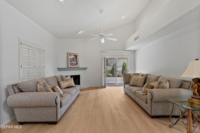 6140 Los Robles Dr, El Paso, TX 79912 - living room with ceiling fan, light wood-type flooring, a fireplace, and high vaulted ceiling
