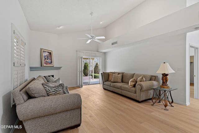 6140 Los Robles Dr, El Paso, TX 79912 - living area featuring ceiling fan, a fireplace, light wood-style flooring, and lofted ceiling