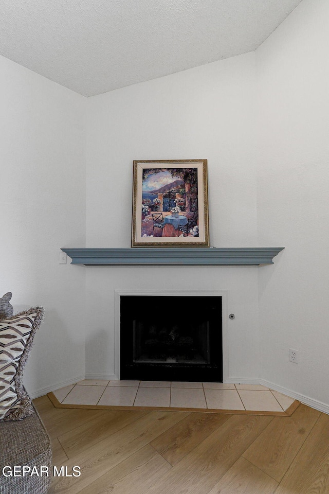 6140 Los Robles Dr, El Paso, TX 79912 - detailed view of a fireplace with flush hearth and wood finished floors