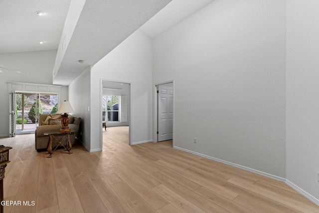 6140 Los Robles Dr, El Paso, TX 79912 - living area featuring high vaulted ceiling, light wood-type flooring, ceiling fan, and recessed lighting