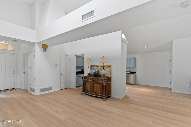 6140 Los Robles Dr, El Paso, TX 79912 - entrance foyer featuring light wood-style flooring and a high ceiling