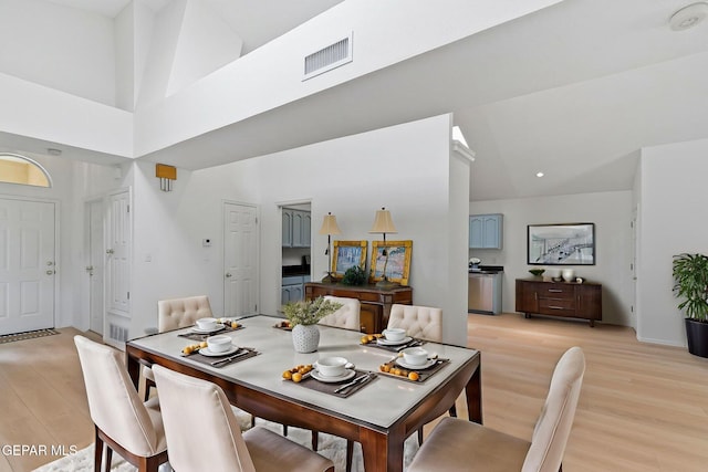 6140 Los Robles Dr, El Paso, TX 79912 - dining room featuring light wood finished floors and a towering ceiling