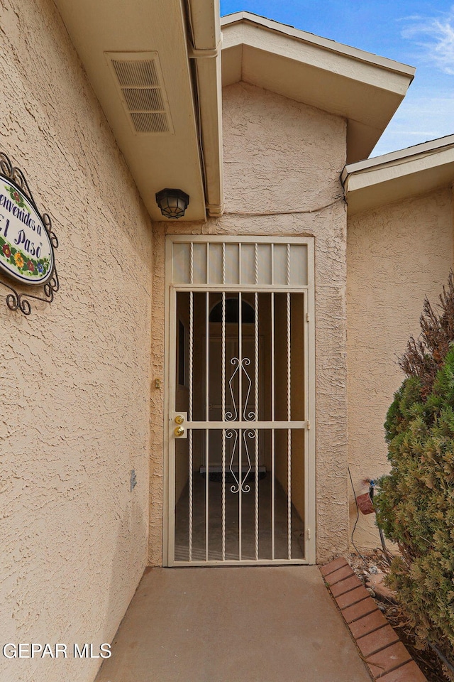 6140 Los Robles Dr, El Paso, TX 79912 - doorway to property with stucco siding