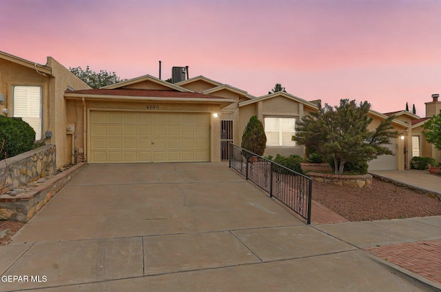 6140 Los Robles Dr, El Paso, TX 79912 - ranch-style house featuring stucco siding, concrete driveway, and a garage