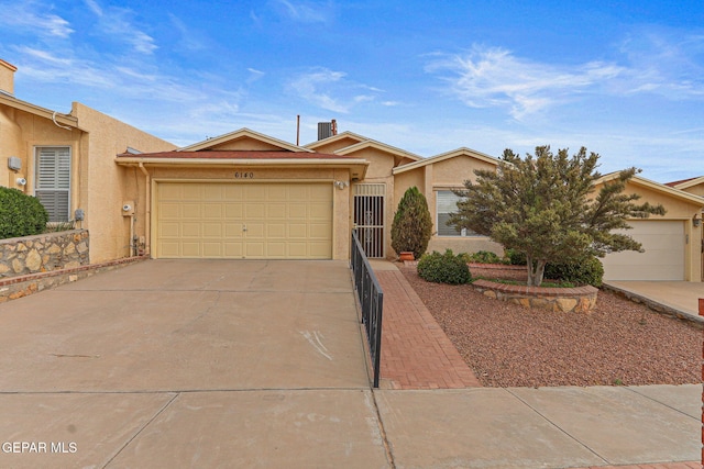 6140 Los Robles Dr, El Paso, TX 79912 - view of front of house featuring stucco siding, concrete driveway, and an attached garage