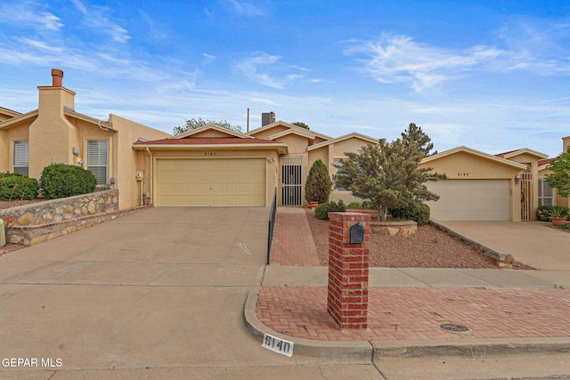 6140 Los Robles Dr, El Paso, TX 79912 - view of front facade with concrete driveway, stucco siding, and a garage