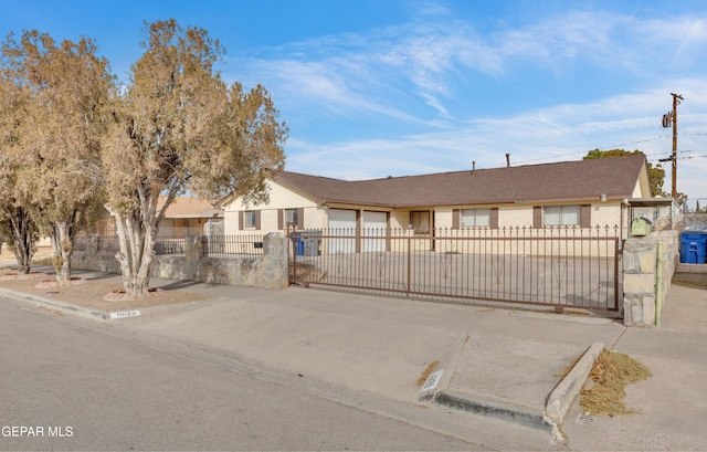 10125 Castletown Dr, El Paso, TX 79925 - single story home with a garage, a fenced front yard, concrete driveway, brick siding, and a gate